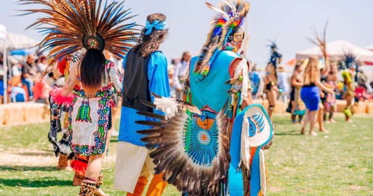 Native Americans Gather in Celebration of Heritage Outside on a Sunny Day