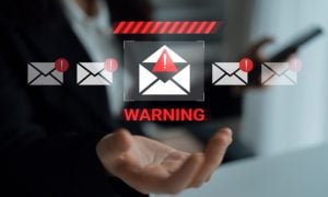 White Envelope with Warning Icon Hovers Above Open Palm