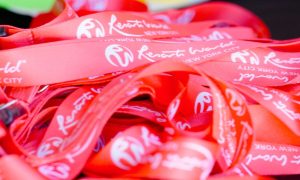 Bright Red Orientation Bracelets Stacked on a Table at Resorts World New York City