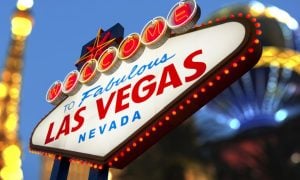 Famous Welcome to Las Vegas Marquee Sign In Focus with Paris Casino Blurred in Background