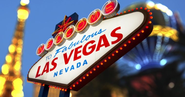 Famous Welcome to Las Vegas Marquee Sign In Focus with Paris Casino Blurred in Background