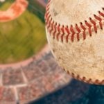 Dirty Baseball Soars High Above a Baseball Stadium Filled with Fans