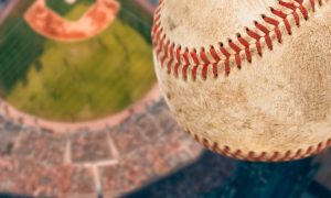 Dirty Baseball Soars High Above a Baseball Stadium Filled with Fans
