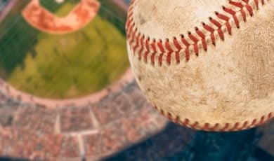 Dirty Baseball Soars High Above a Baseball Stadium Filled with Fans