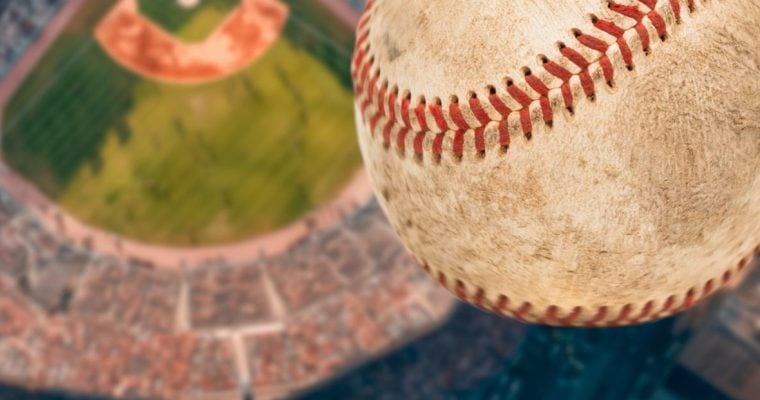Dirty Baseball Soars High Above a Baseball Stadium Filled with Fans