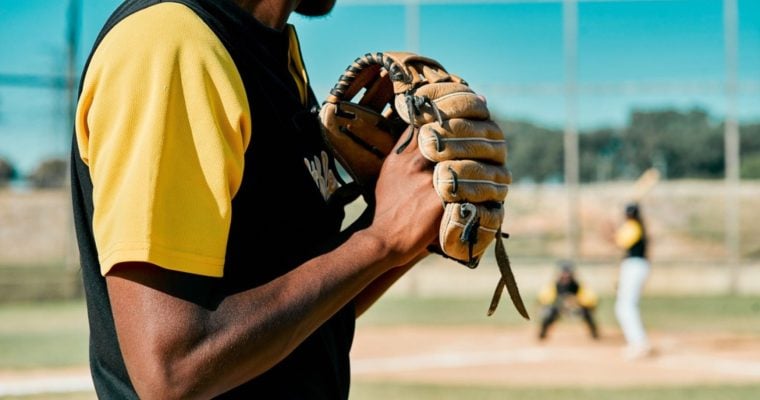Sunny Day on an Outdoor Baseball Field with Close Up of Pitcher Gearing Up for a Pitch