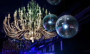 Camera Flash Lights Up Disco Balls and Huge Chandelier Hanging Inside Night Club