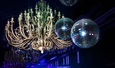 Camera Flash Lights Up Disco Balls and Huge Chandelier Hanging Inside Night Club