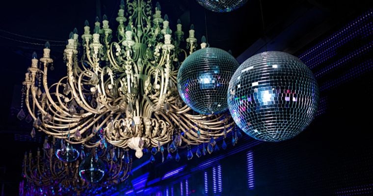 Camera Flash Lights Up Disco Balls and Huge Chandelier Hanging Inside Night Club