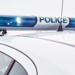 White Police Car Features Blue Lights on Top With Word Police In Center