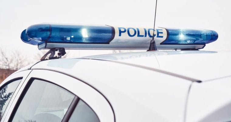 White Police Car Features Blue Lights on Top With Word Police In Center