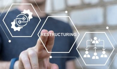 Man Points with Two Fingers to the Word Restructuring in Digital Icon Overlay
