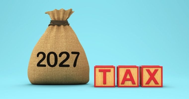 Brown Pouch Says 2027 Sitting Next To Wooden Blocks Spelling the Word TAX in Red