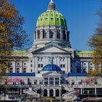Autumn Trees Surround The Capital Building in Pennsylvania with Blue Skies Background