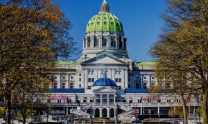 Autumn Trees Surround The Capital Building in Pennsylvania with Blue Skies Background
