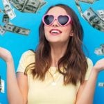 Falling Cash On Blue Background Surrounds Young Happy Woman