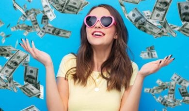 Falling Cash On Blue Background Surrounds Young Happy Woman