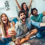 Group of Young People Celebrates While Watching Soccer Match At Home