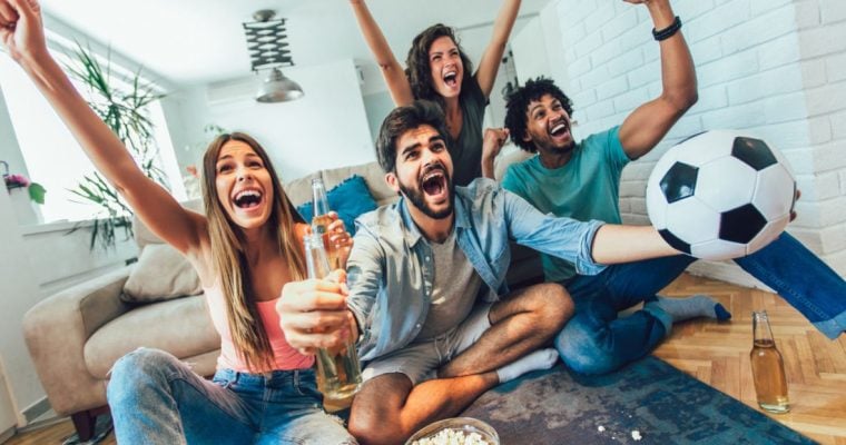 Group of Young People Celebrates While Watching Soccer Match At Home