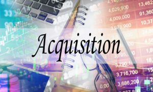 Stock Numbers, Notebook, Glasses and Laptop Background to the Word Acquisition in Black Font