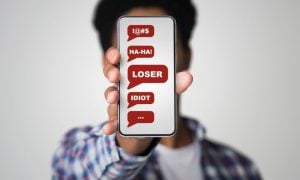 Negative Messages Displayed on Man's Cell Phone Covering His Face