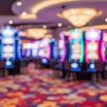 Blurry Image of Colorful Slot Machines on Casino Floor