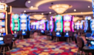 Blurry Image of Colorful Slot Machines on Casino Floor