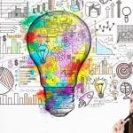 Sketched Light Bulb Above Woman's Head Contains Images Of Mathematics and Statistics