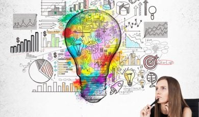 Sketched Light Bulb Above Woman's Head Contains Images Of Mathematics and Statistics