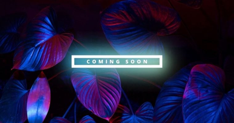 Red and Blue Lights Highlight Plant Foliage with White Neon Coming Soon Text