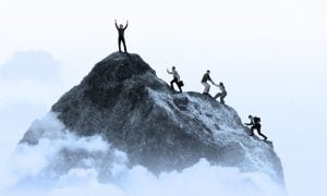 A Group of People Climb Grey Mountain Toward Peak on White Background