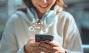Young Woman Holding Cell Phone Converses With an AI Chatbot