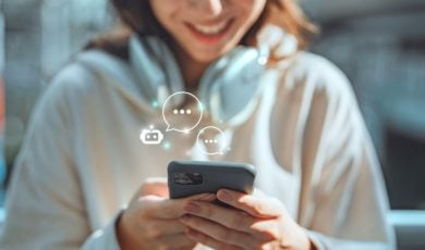 Young Woman Holding Cell Phone Converses With an AI Chatbot