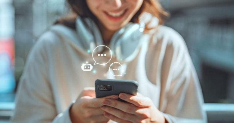 Young Woman Holding Cell Phone Converses With an AI Chatbot