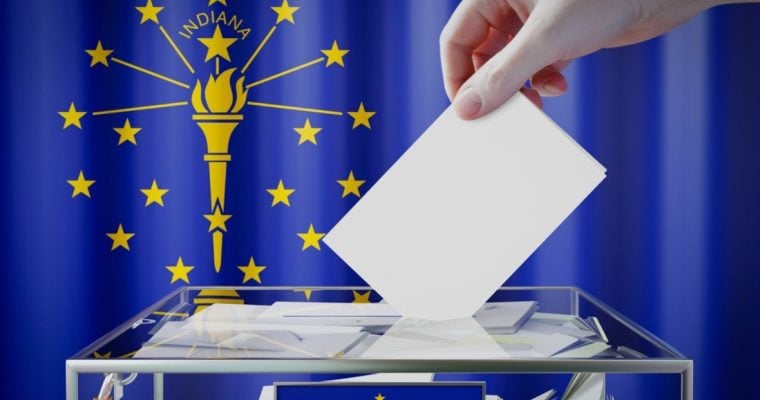 Hand Drops White Envelope Into Clear Box with Indiana State Flag Background