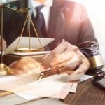 Several Images Exposed Over Each Other: Man in Black Suit, Judges Gavel, Gold Scales and Legal Papers