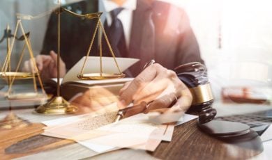 Several Images Exposed Over Each Other: Man in Black Suit, Judges Gavel, Gold Scales and Legal Papers