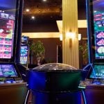 Two Slot Machines With Large Display Screens Feature Brightly Lit Games inside Casino