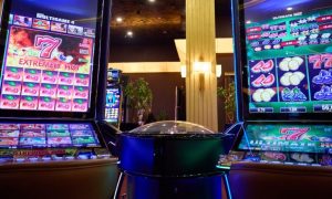 Two Slot Machines With Large Display Screens Feature Brightly Lit Games inside Casino