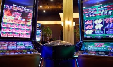 Two Slot Machines With Large Display Screens Feature Brightly Lit Games inside Casino