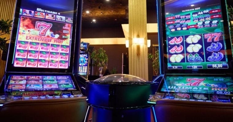 Two Slot Machines With Large Display Screens Feature Brightly Lit Games inside Casino