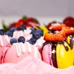Pink and Yellow Macaroons with Strawberry and Blueberry Topping