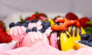 Pink and Yellow Macaroons with Strawberry and Blueberry Topping