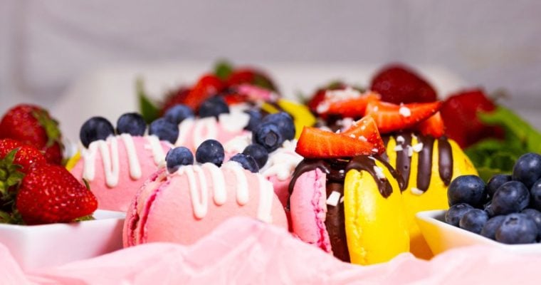 Pink and Yellow Macaroons with Strawberry and Blueberry Topping