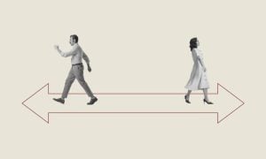 Man and Woman Walk Away in Opposite Direction on Red Arrow