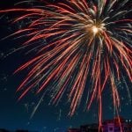 Single Orange Firework In Dark Blue Night Sky