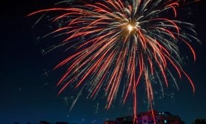 Single Orange Firework In Dark Blue Night Sky