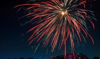 Single Orange Firework In Dark Blue Night Sky