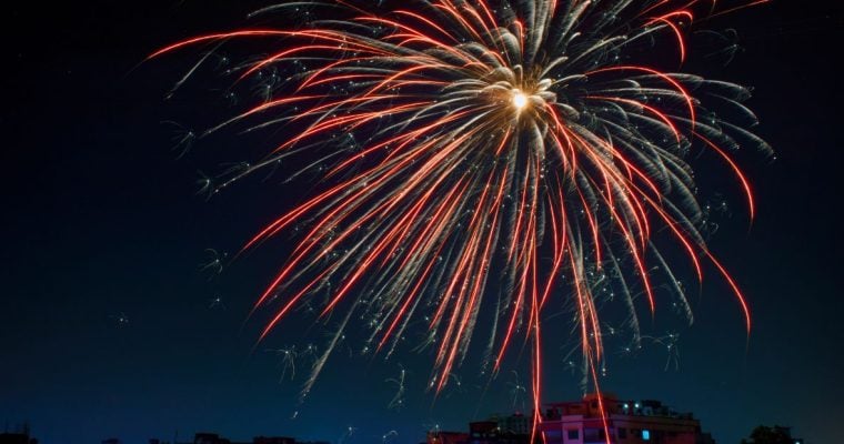 Single Orange Firework In Dark Blue Night Sky