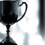 Close-up of Platinum Trophy with Handles on White Lights Background